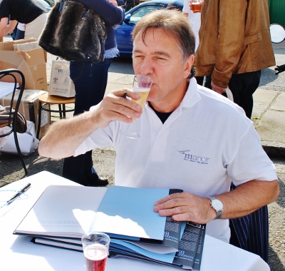 Raymond Blanc takes some refreshment from signing his book at a previous Thame Food Festival, of which he is Patron