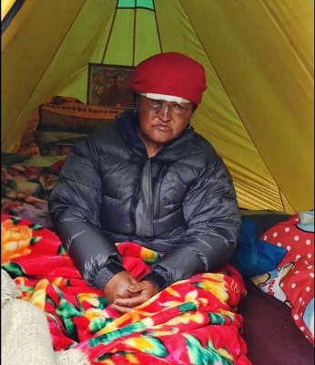 A village of Thame, in Nepal, with a bandaged head, sits in a tent, his home destroyed in the earthquake