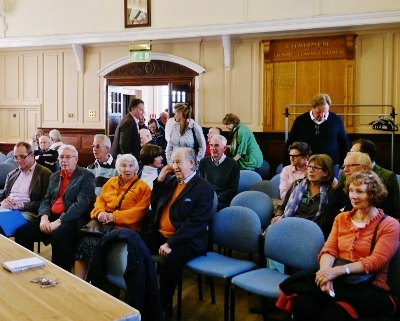 Local people begin filing in the council chamber 