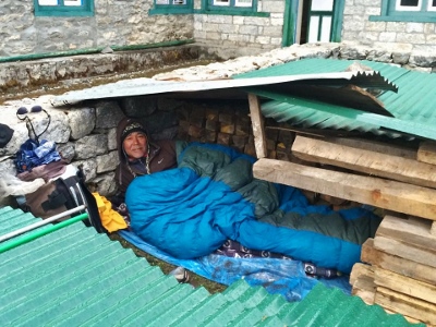 A  villager in a make-shift shelter, in the Nepalese Sherpa village of Thame