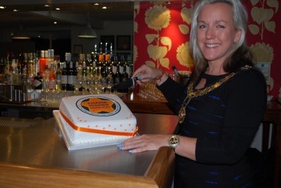 Mayor of Thame, Nichola Dixon, cuts the 'Rising Star' cake