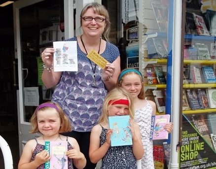 Rosa Horsman (R) with her younger sisters, and Clare Davidson, Oxfam Book shop Manager